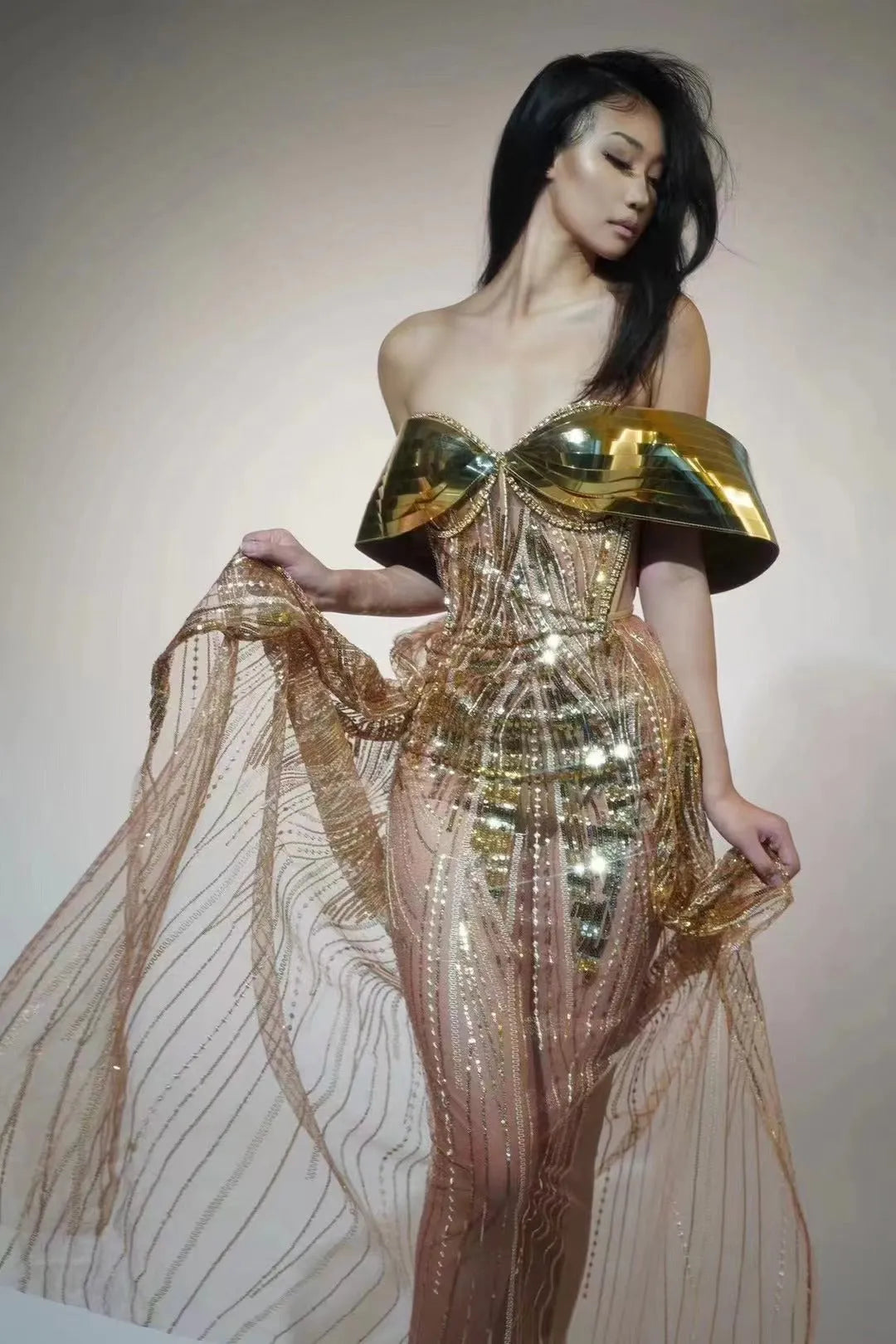 Gold strapless sequined evening dress with a high split tulle skirt.