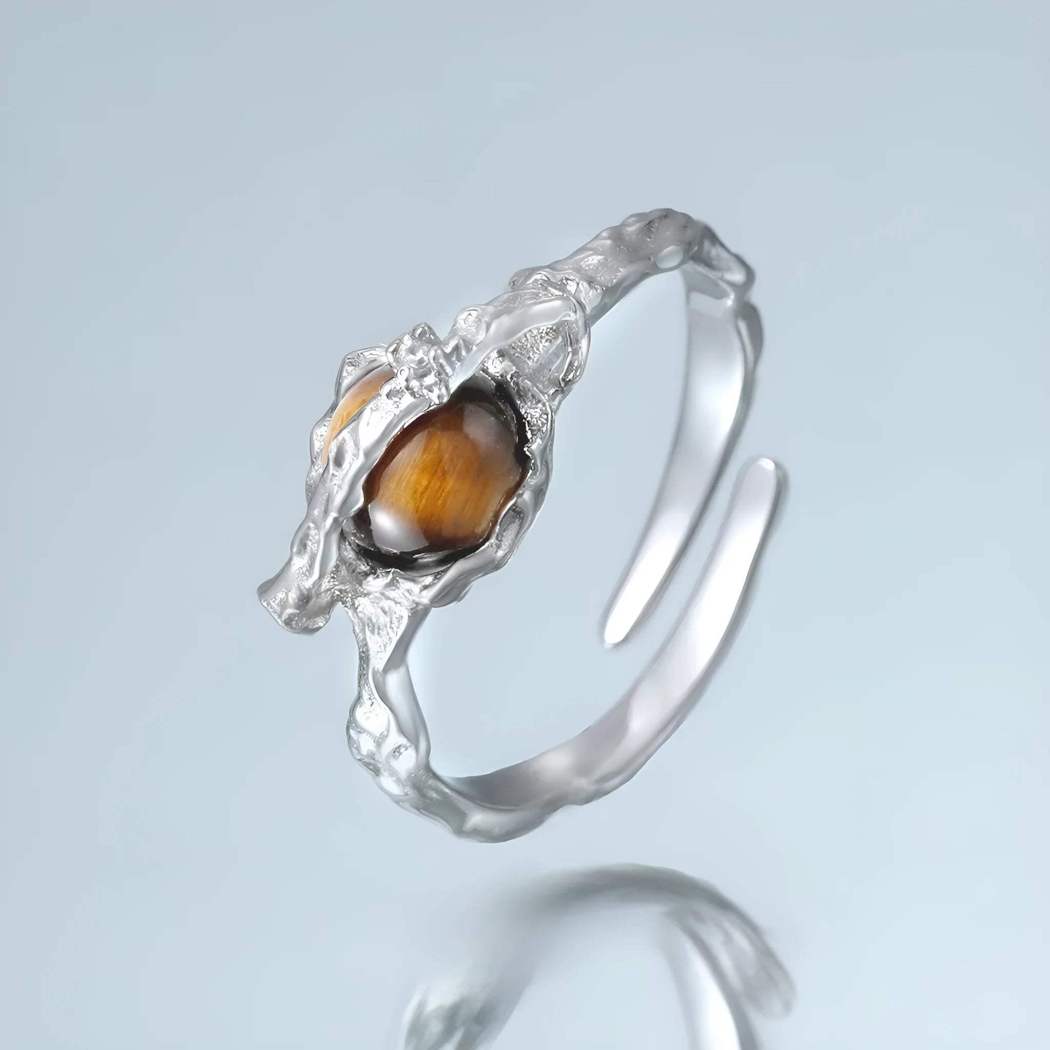White gold coloured Saturn open ring with adjustable sizing on silver base