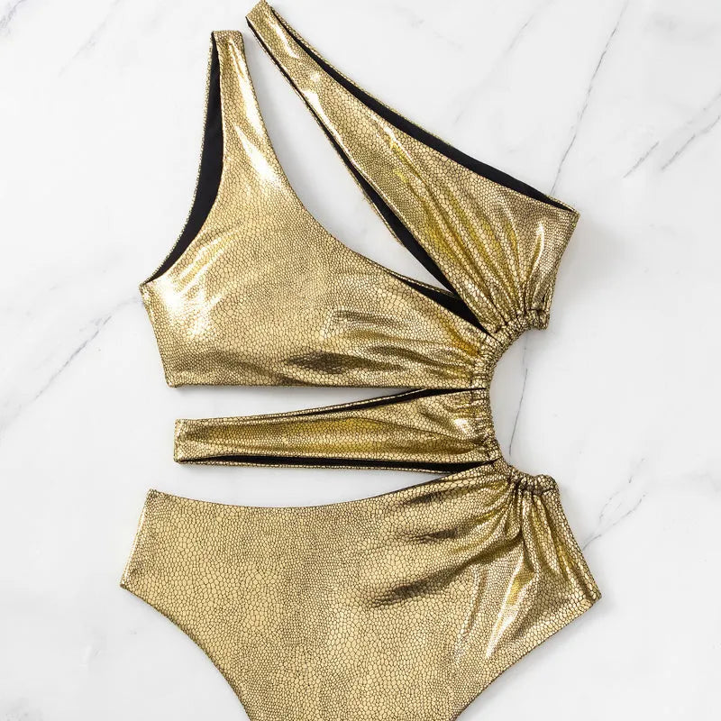 Women's gold backless one-piece swimsuit on hanger showing spandex material and European American style