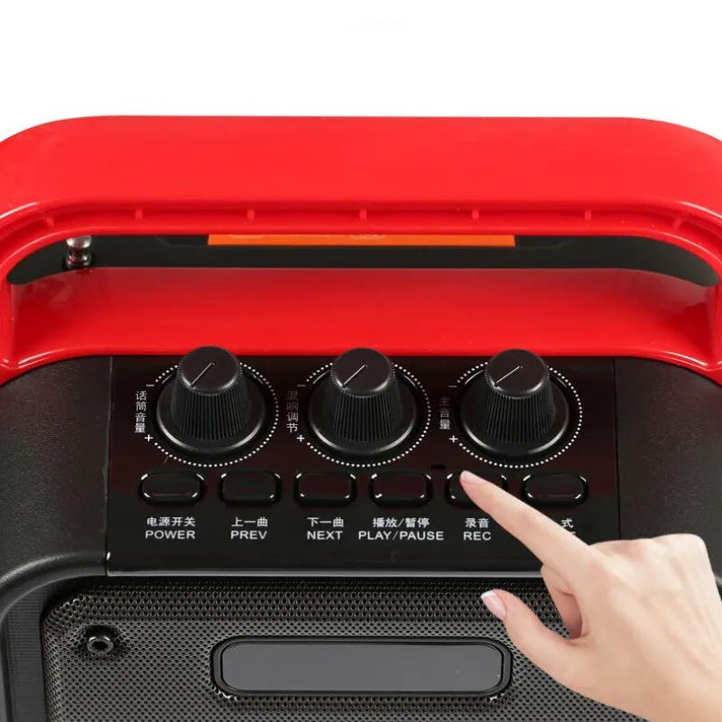 MS62AI portable Bluetooth speaker with wireless microphone and remote control on a table.