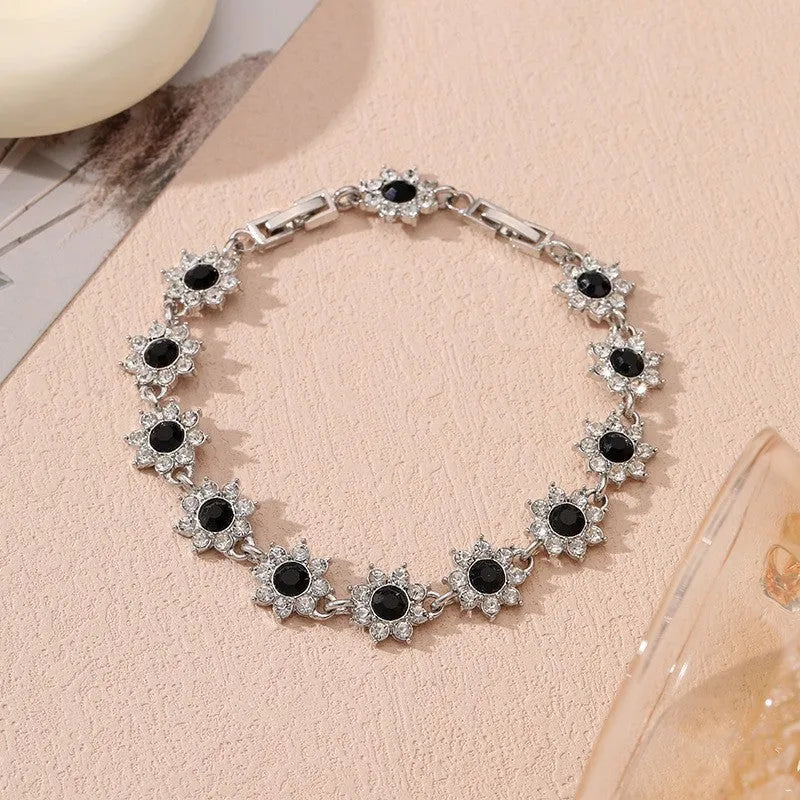 Gold and silver electroplated flower bracelet with coloured gemstone accents on zinc alloy