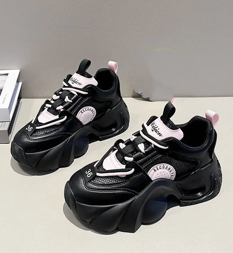 Women's pink sneakers with cross straps and a thick white platform sole.