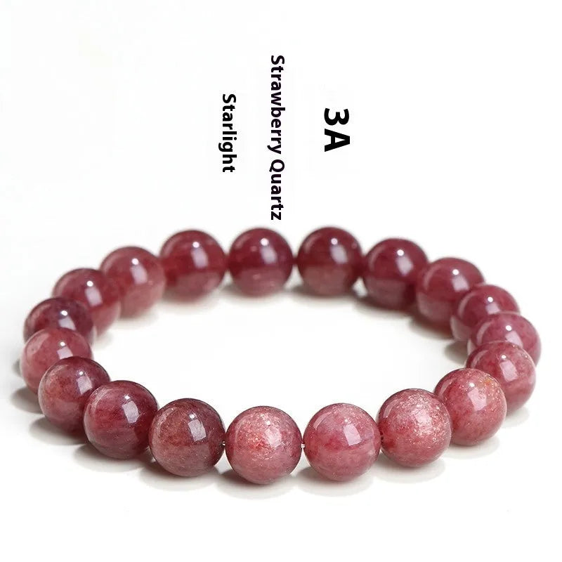 Natural strawberry quartz bracelet with geometric red crystal beads on a white background