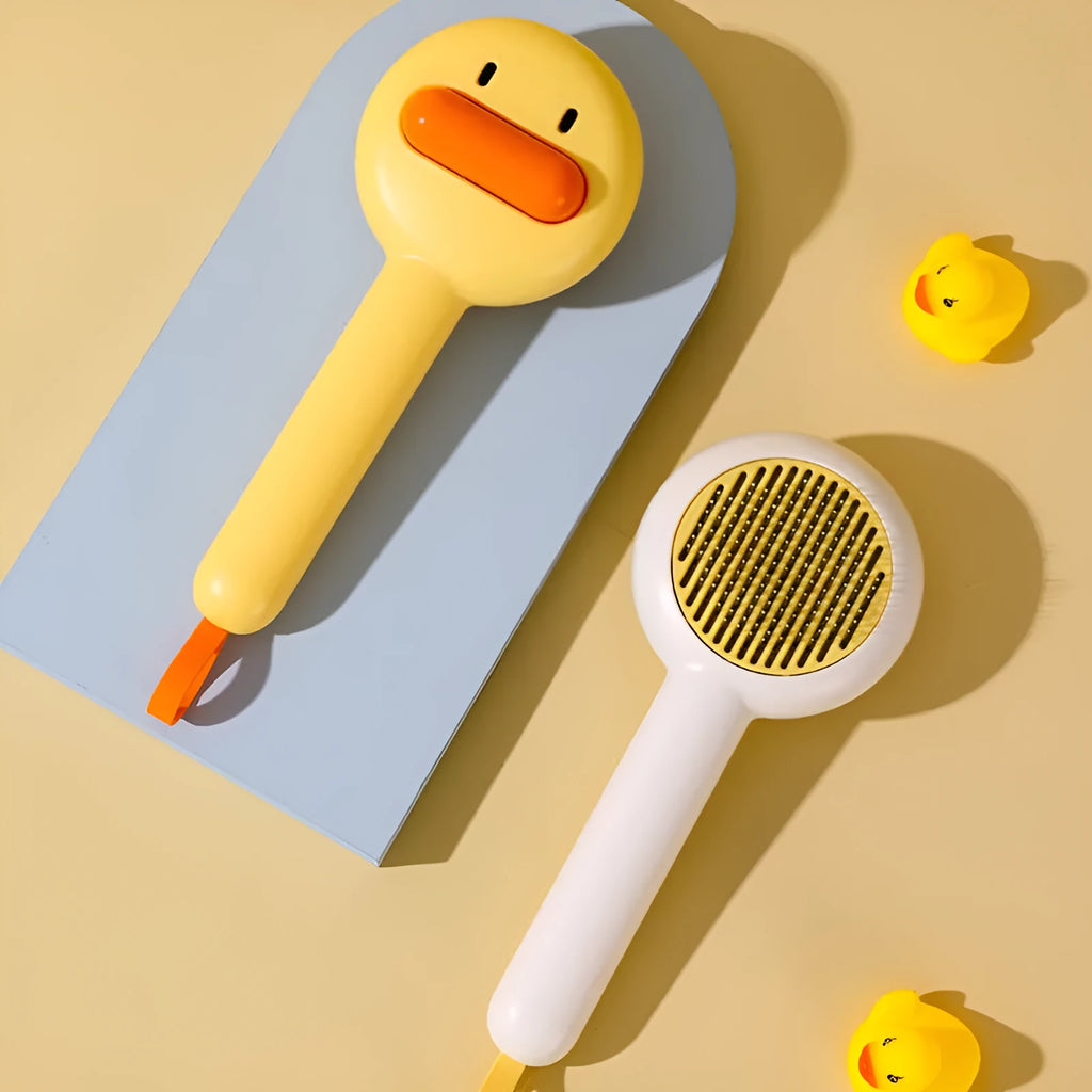 Small yellow duck-shaped pet grooming comb with open section design for cat and dog hair removal