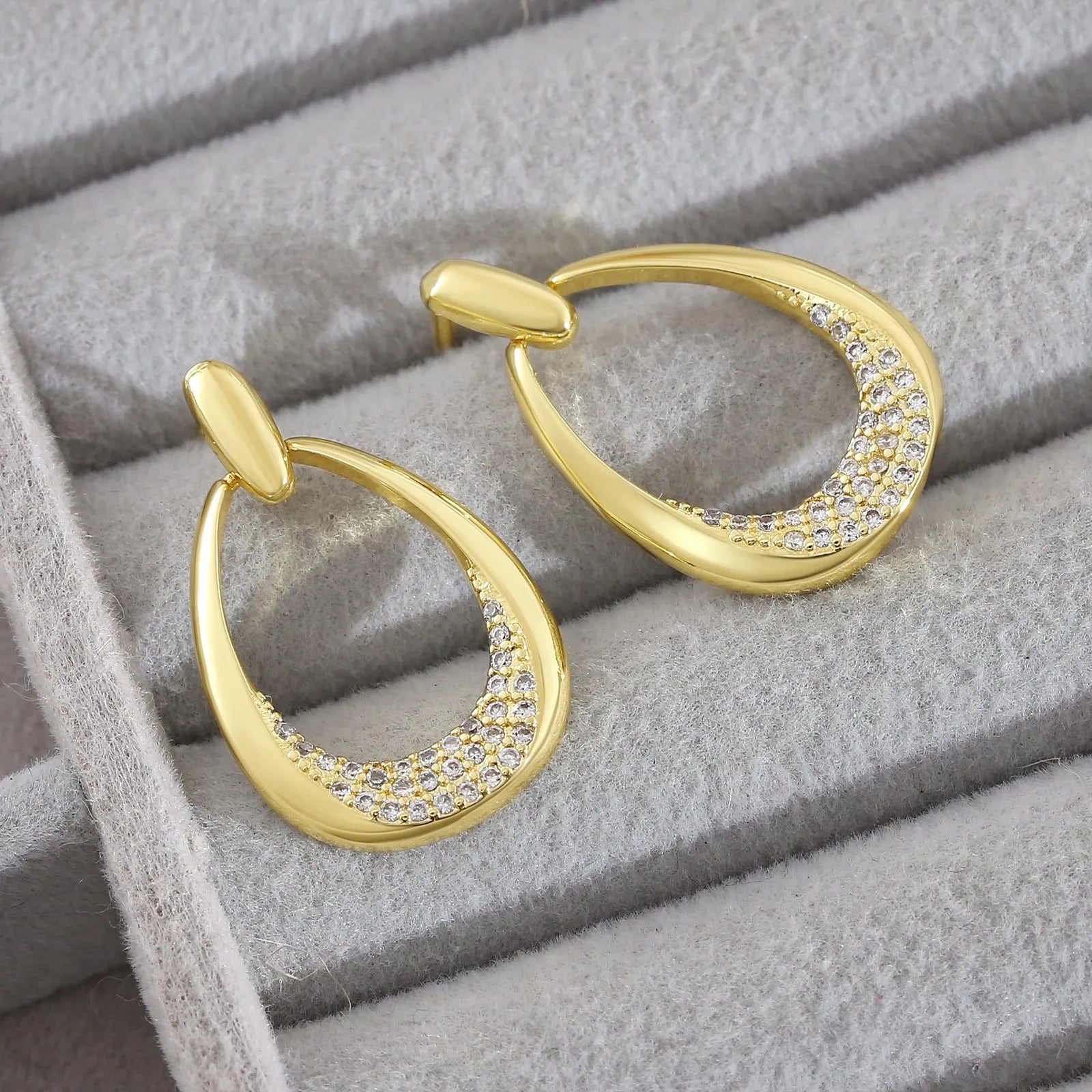 Yellow gold geometric drop earrings for women with a simple ring-style design.