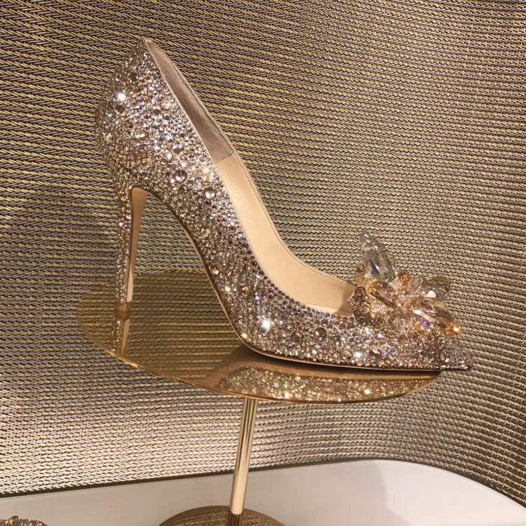Gold women's pointed toe stiletto high heels with rhinestone and sequin decoration on a shallow-mouth, low-top upper.