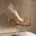 Gold women's pointed toe stiletto high heels with rhinestone and sequin decoration on a shallow-mouth, low-top upper.