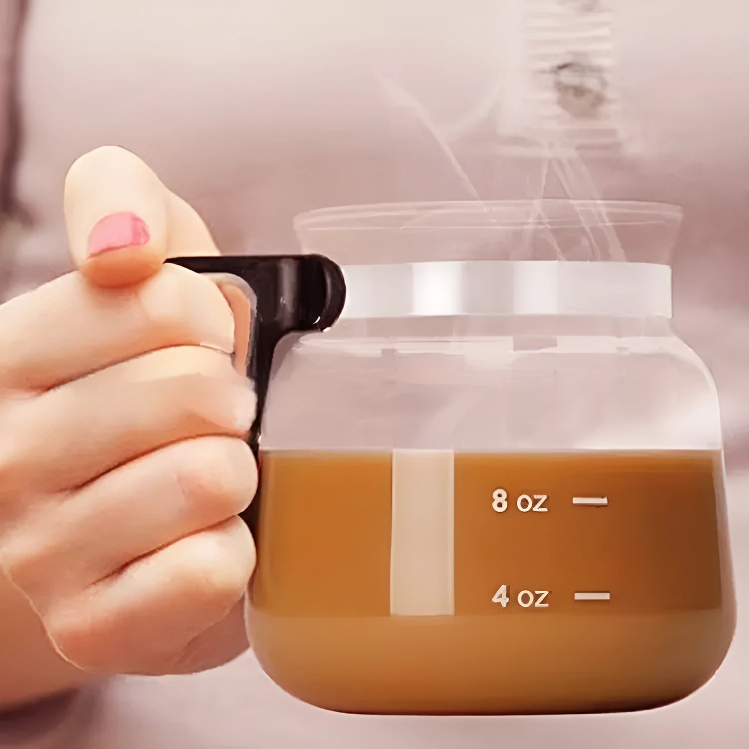 Transparent borosilicate glass coffee maker with a black silicone cover, showing 355-473 ml capacity.