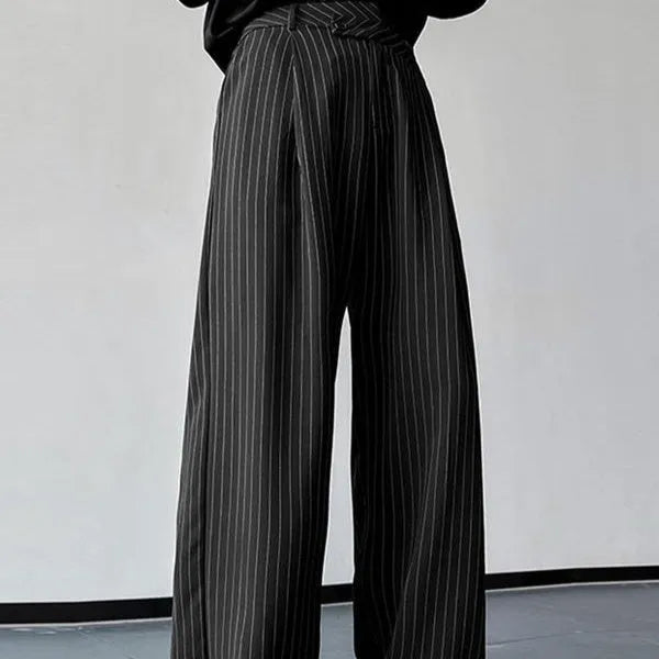 Black men's trousers with vertical stripes and pleats, made from an elastic rabbit hair and bamboo fibre blend.