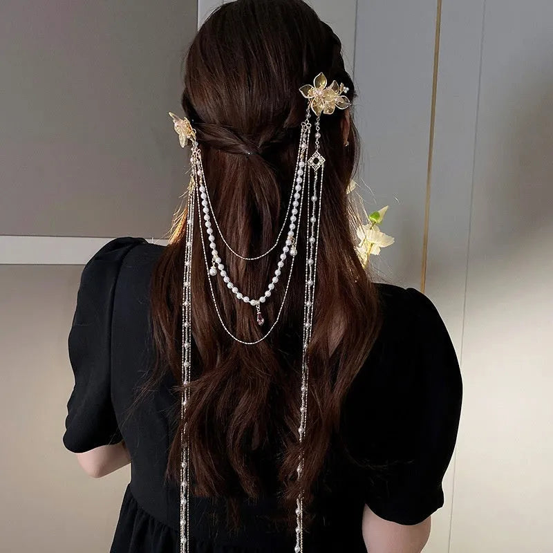 Gold grip hairpin for women with pearl, diamond, flower decorations and a long tassel.
