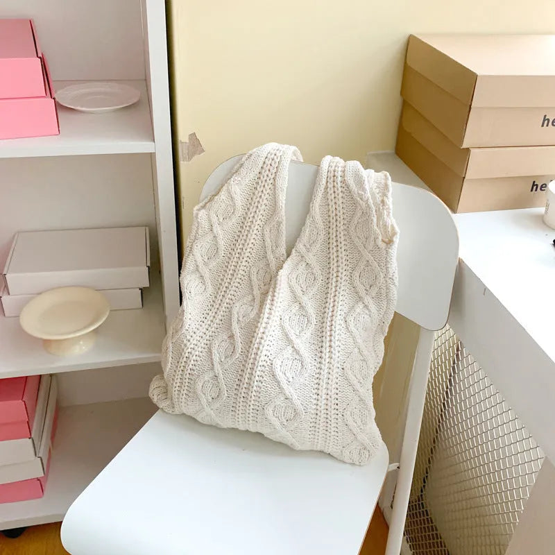 Knitted wool yarn shoulder tote bag with hollow crochet design in solid colour