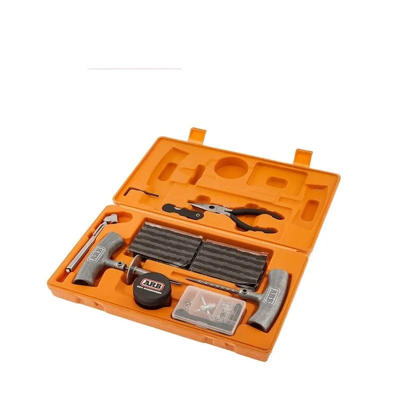 Open case showing emergency tyre repair tool set with reamer, insertion tool, pressure gauge, pliers, knife, and hex wrench.
