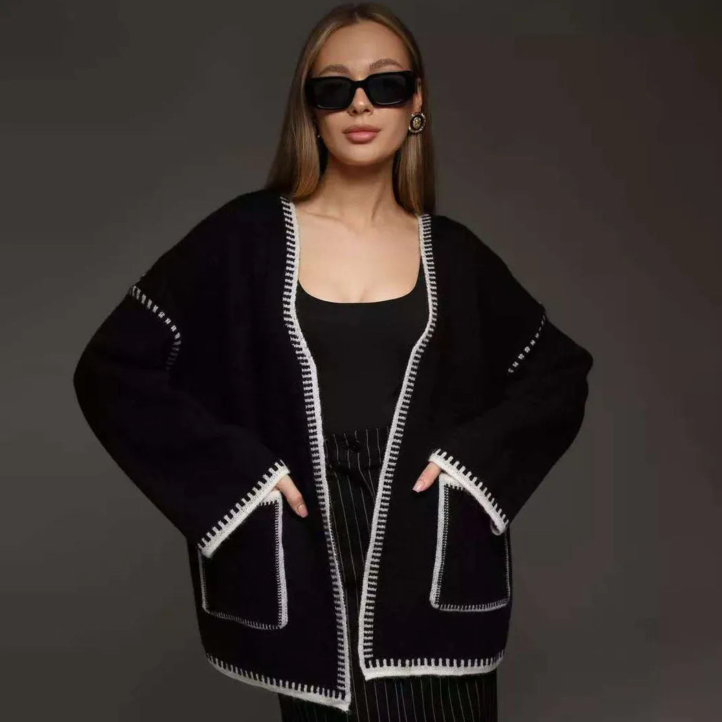 Lace-up front knitted cardigan sweater coat in camel colour, showing loose fit and long sleeves.