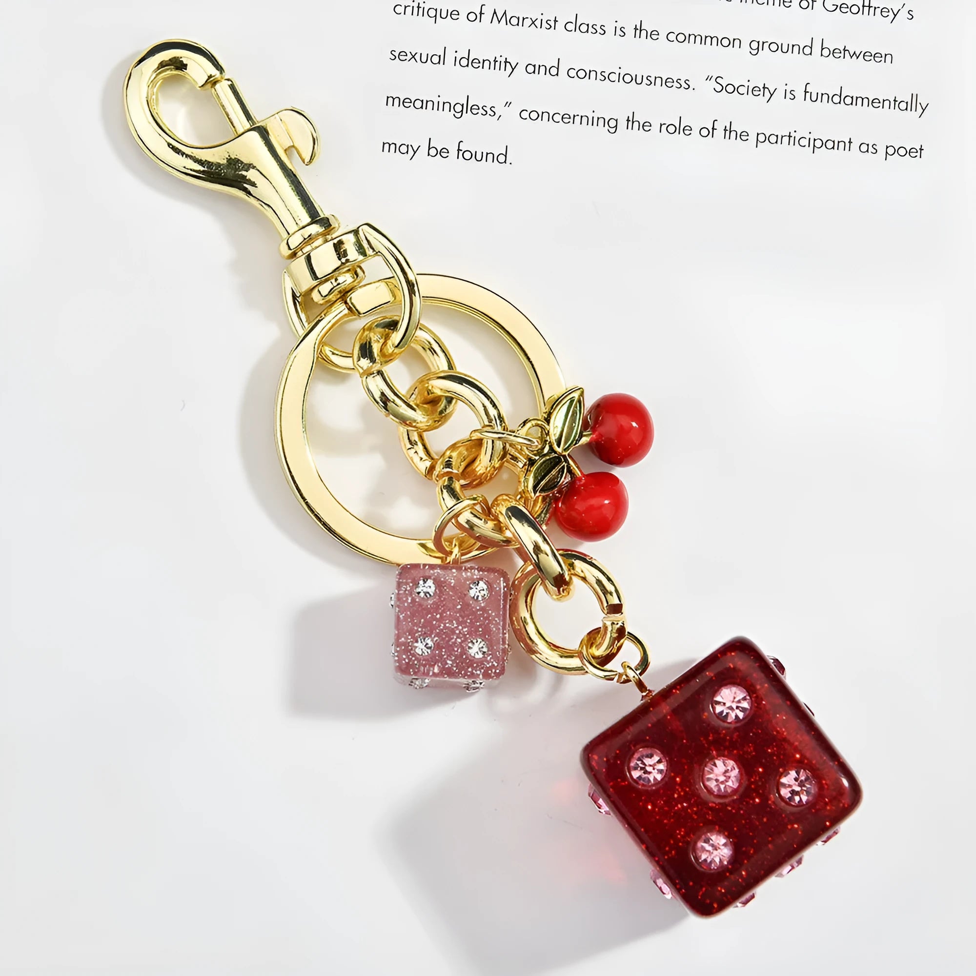 Square cherry two-tone dice keychain pendant on a metal ring.