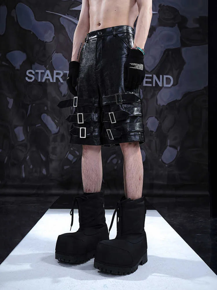 Men's black PU leather cropped shorts on a neutral background