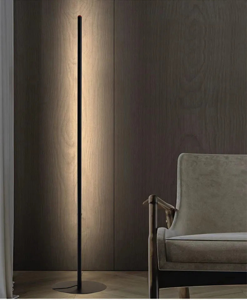 A tall, vertical aluminium alloy floor lamp with a modern design on a simple base.