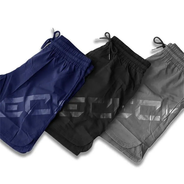 Man wearing black knee-length nylon running shorts during summer training.