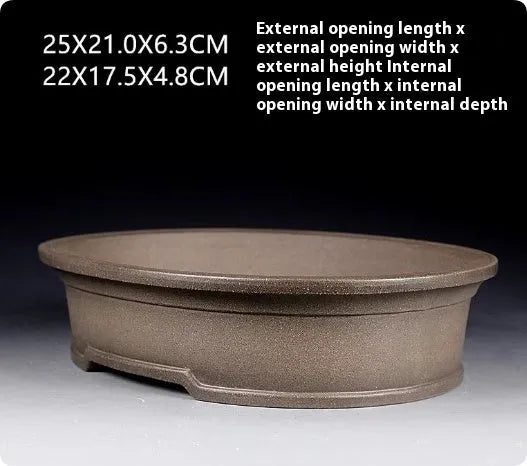 Handmade antique oval bonsai flower pot in purple sand for succulent plants.