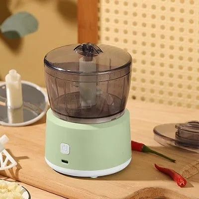 White and light green mini electric meat grinder with transparent cup and stainless steel blades