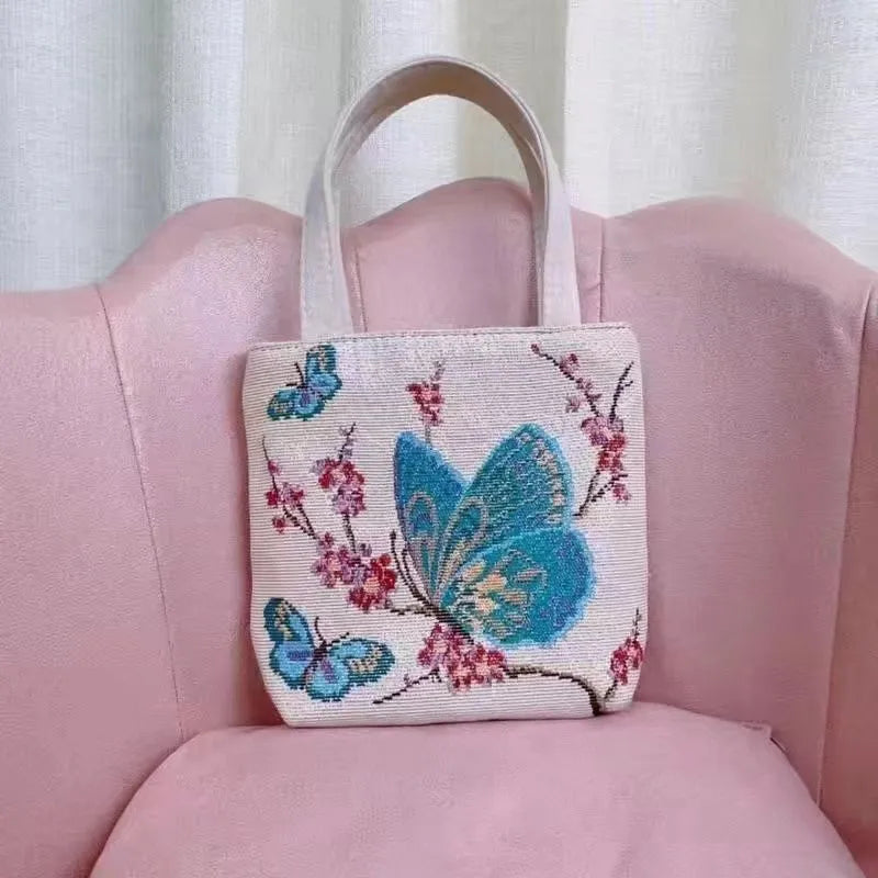 Handheld canvas bag with gold wire embroidery, shown in one of seven colour designs.