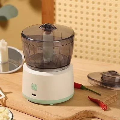 White and light green mini electric meat grinder with transparent cup and stainless steel blades