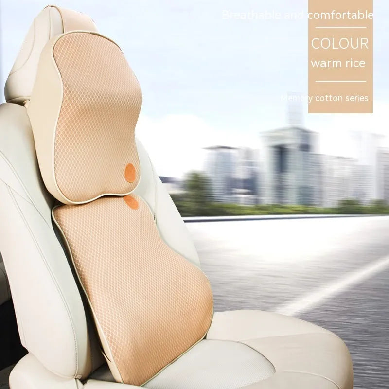 Black and brown memory foam car headrest and lumbar support pillows on a car seat.
