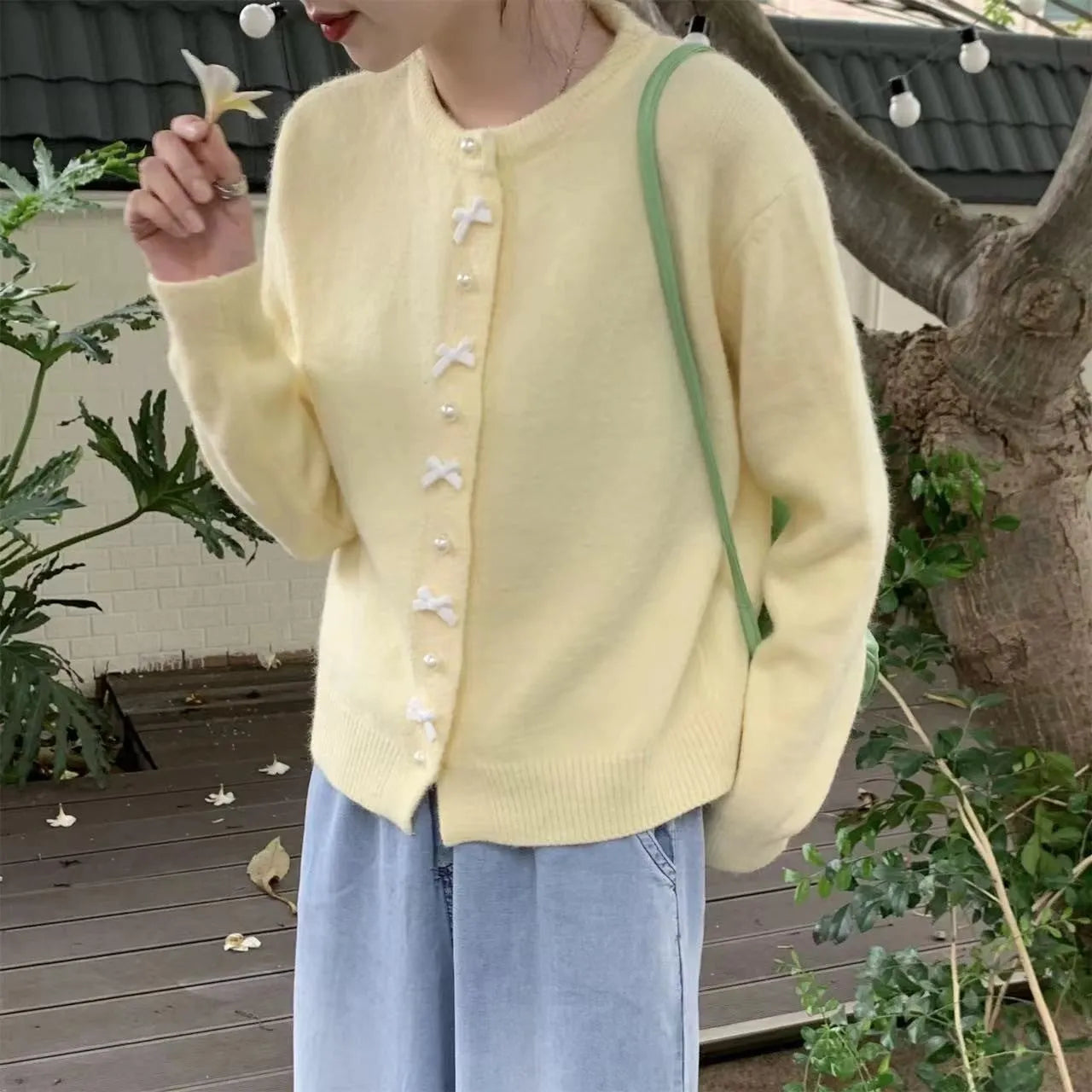 Women's acrylic cashmere cardigan sweater with bow and pearl button detail in nine colour options