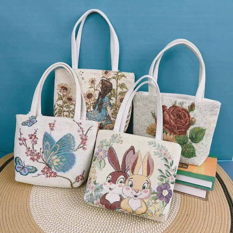 Handheld canvas bag with gold wire embroidery, shown in one of seven colour designs.