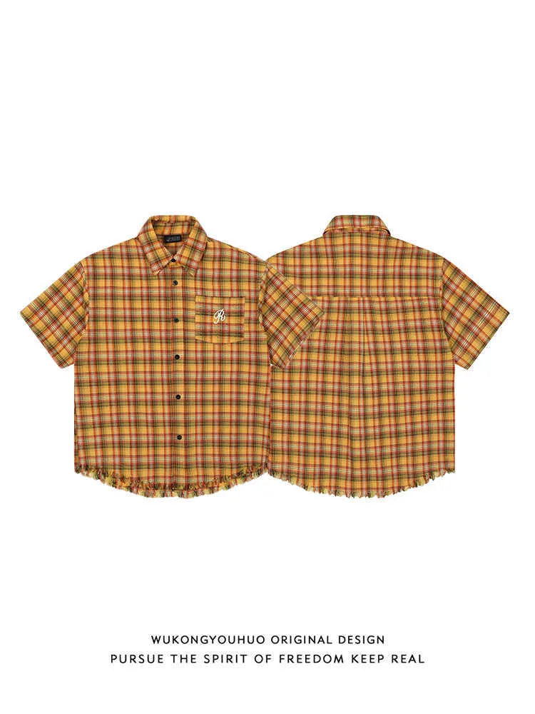 Yellow grid plaid short sleeve shirt with an embroidered chest pocket, shown in a loose unisex fit.