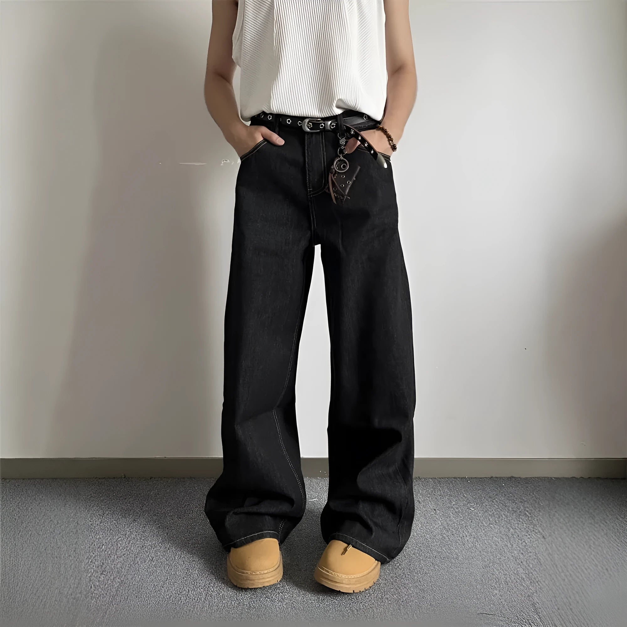 A pair of black loose wide-leg jeans with a straight-leg cut and zip fly on a mannequin.