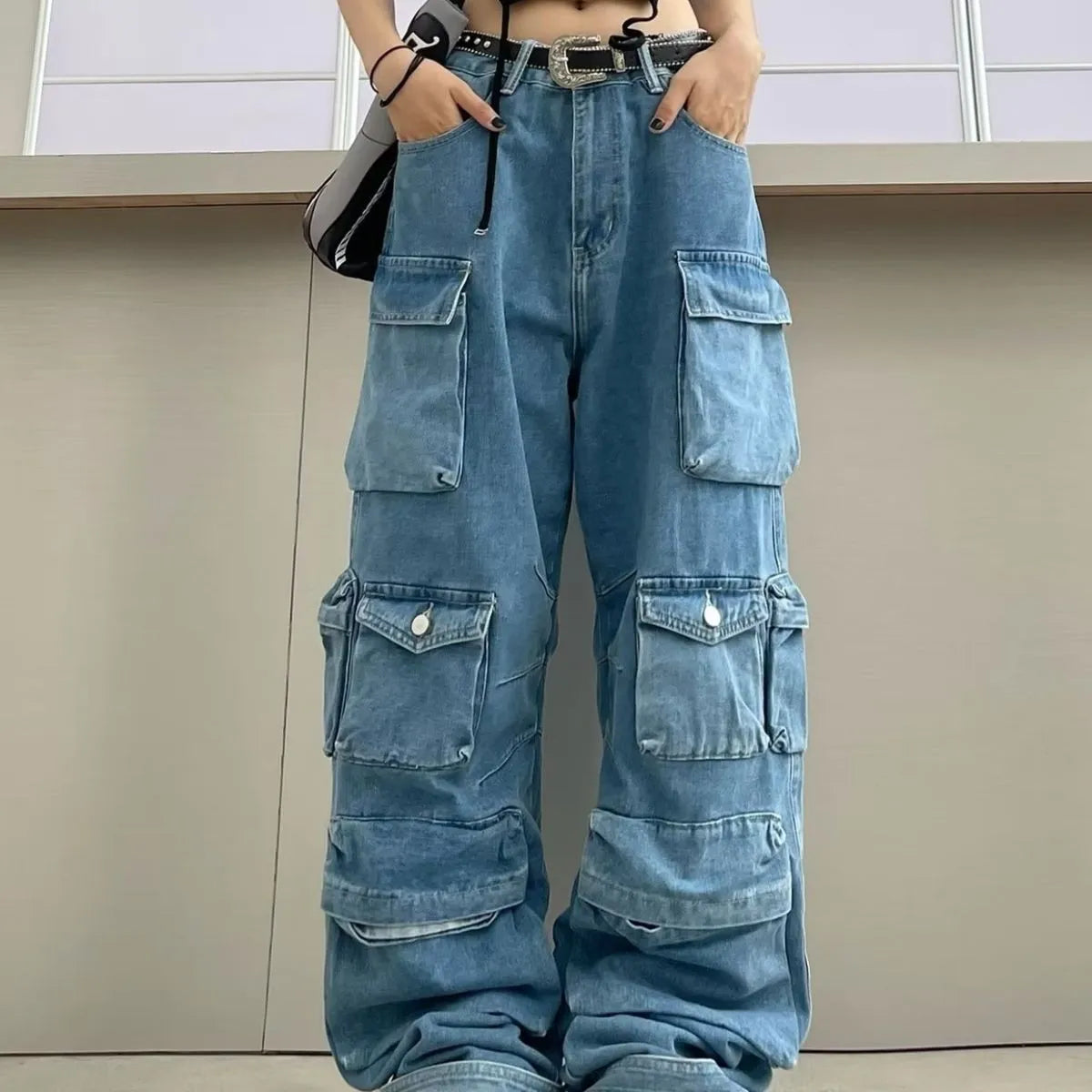 Woman wearing blue tie-dyed high waist wide leg denim trousers with multiple pockets