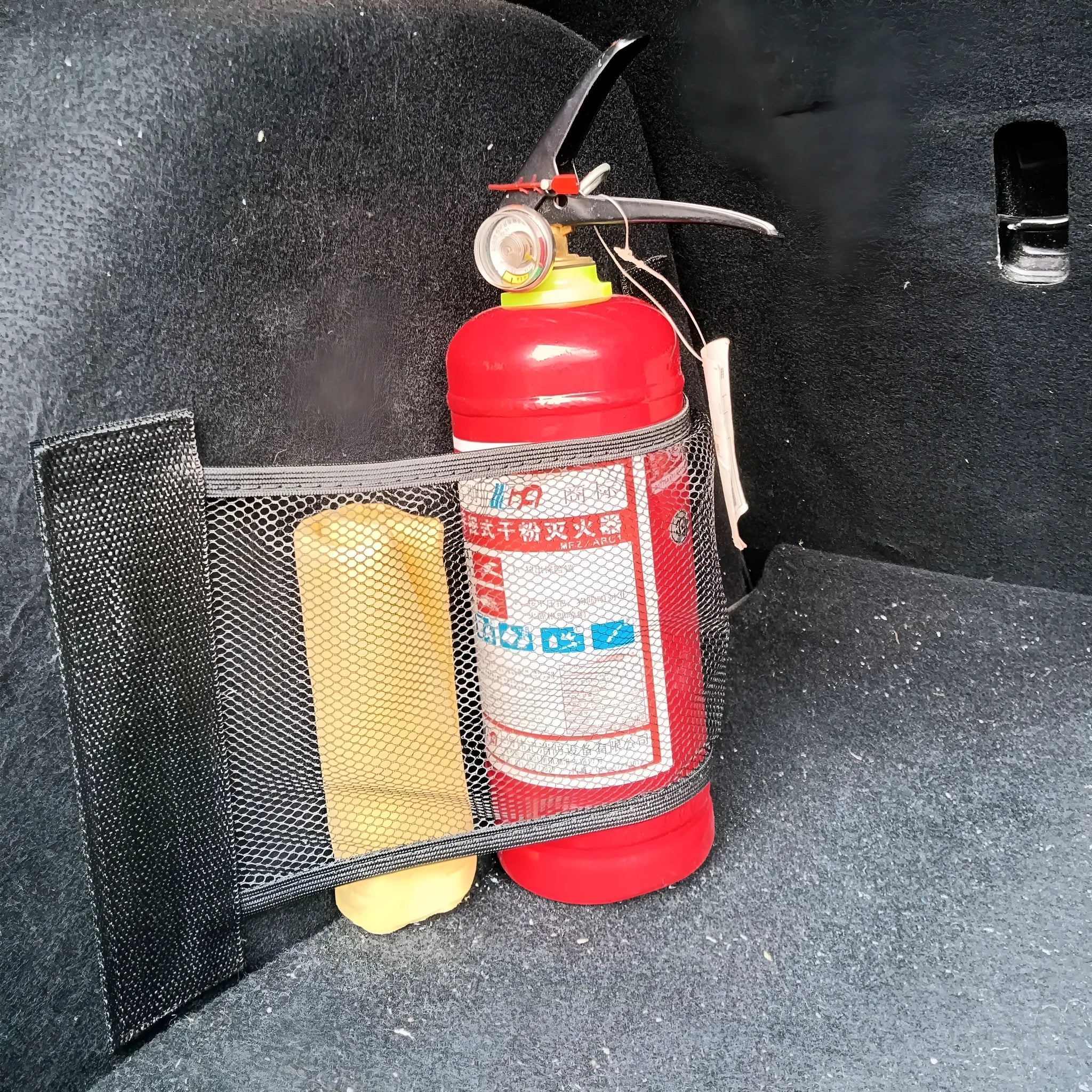 Elastic polyester car boot storage net shown holding shopping bags, available in 20x45cm or 20x35cm sizes.