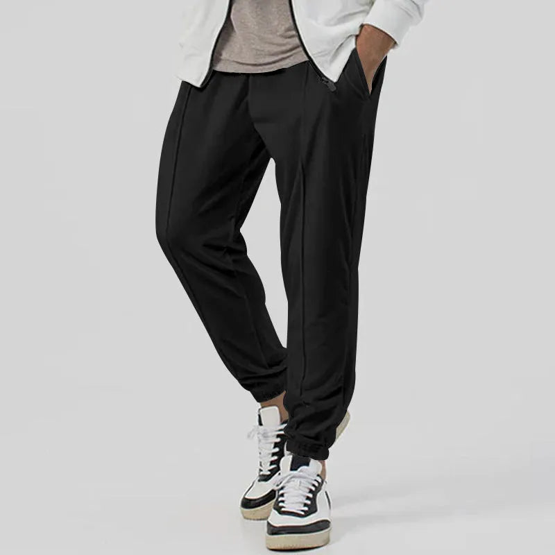 Men's loose tapered casual sweatpants in a grey cotton blend fabric with an elastic waistband.