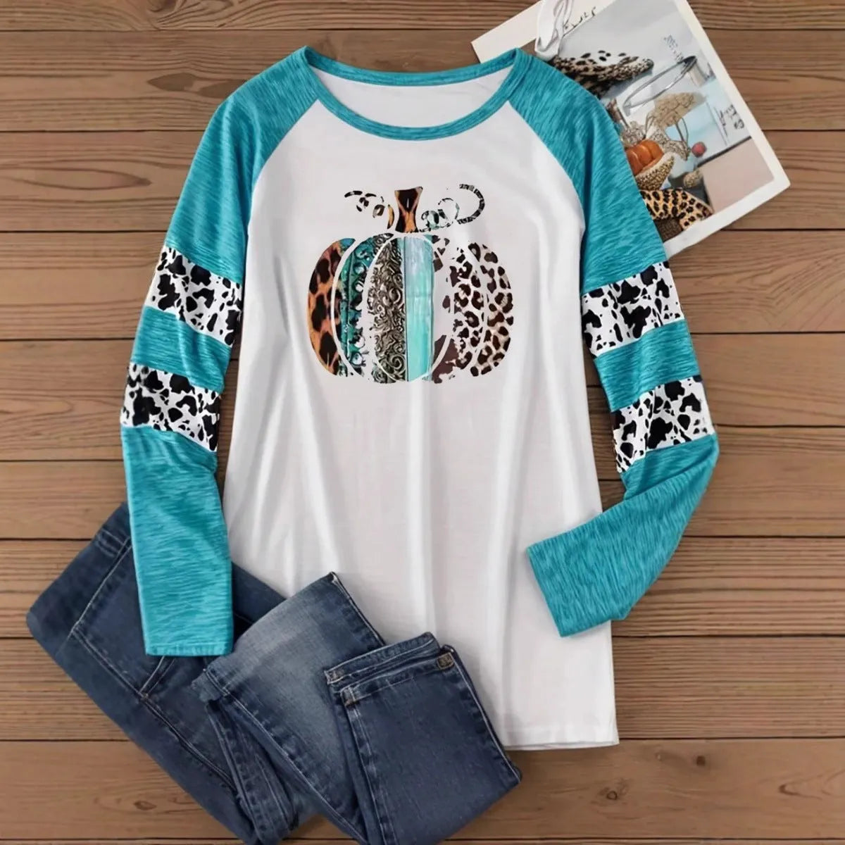 Sky blue long sleeve t-shirt with a large 3D digital printed Halloween pumpkin design on the front.