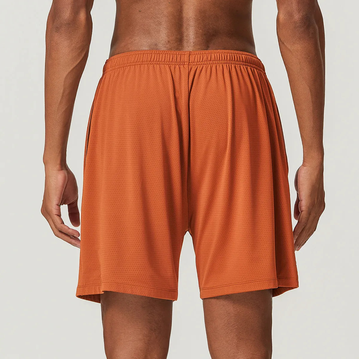 Men's double-layer running shorts in sky green, showing mid-waist fit and shorts length.