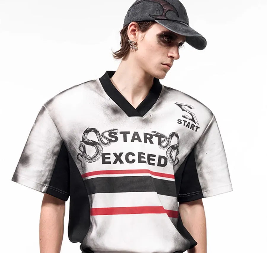 Women's black V-neck short sleeve top with white letter snake pattern print and padded shoulders.