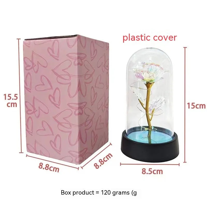 Small plastic night lamp with glass cover and flower decoration on black base