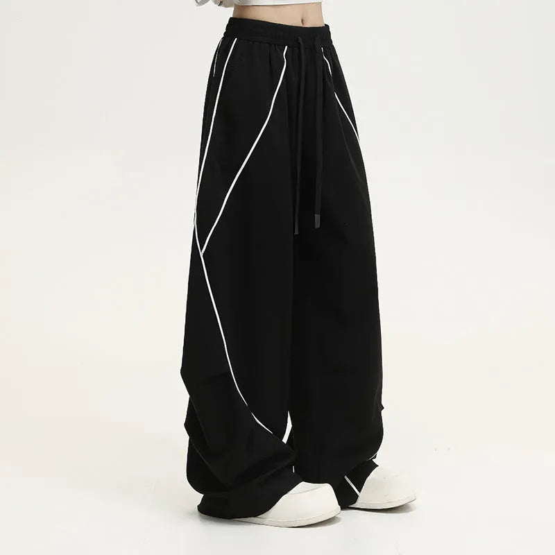 Black pleated hip hop trousers with wide-leg design and stripe pattern