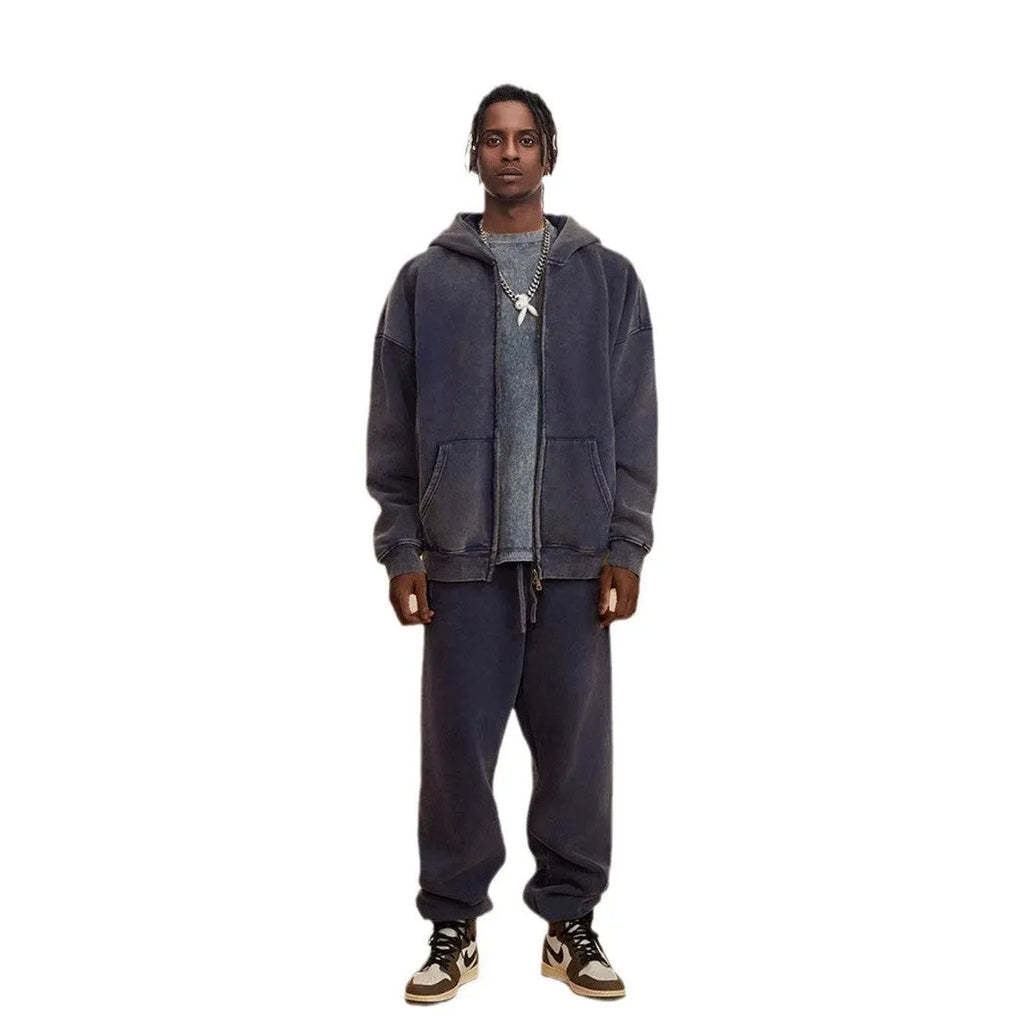 Man wearing a washed black fleece-lined cotton hooded cardigan with a double zipper.