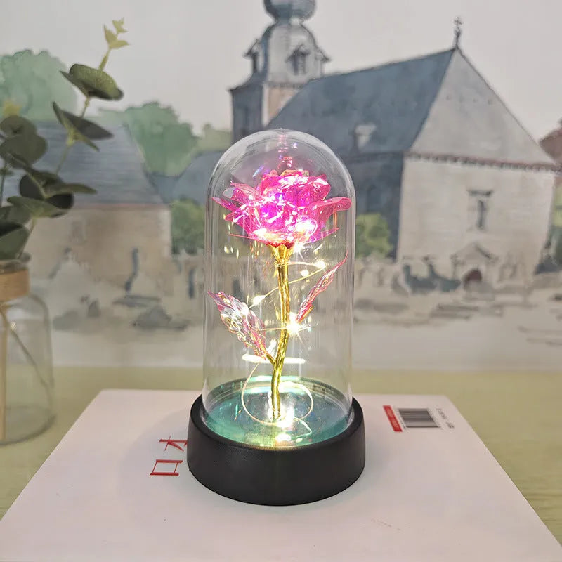 Small plastic night lamp with glass cover and flower decoration on black base
