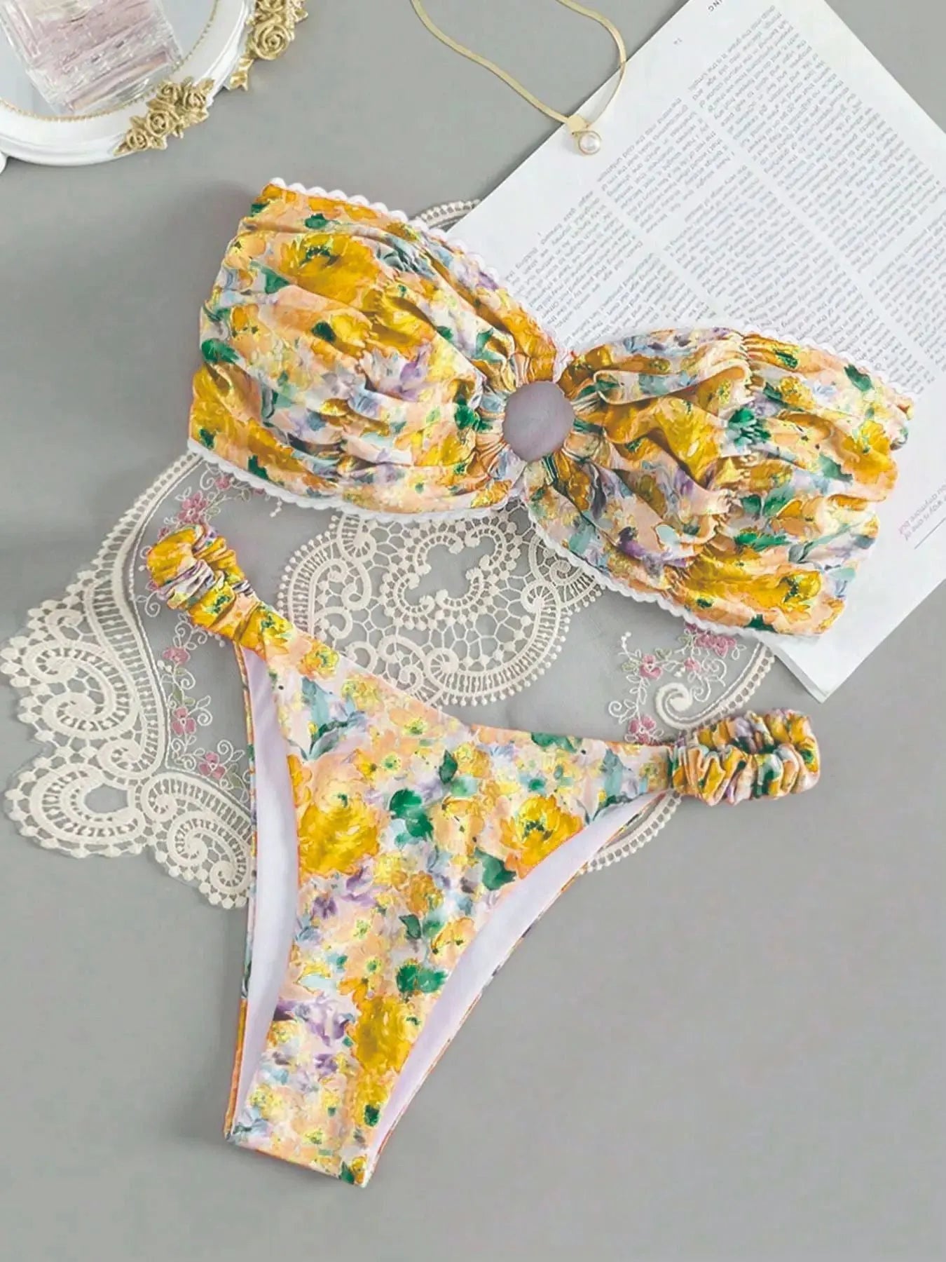 Women's tube top bikini set with lace trim in blue, yellow, pink, and floral print colours.