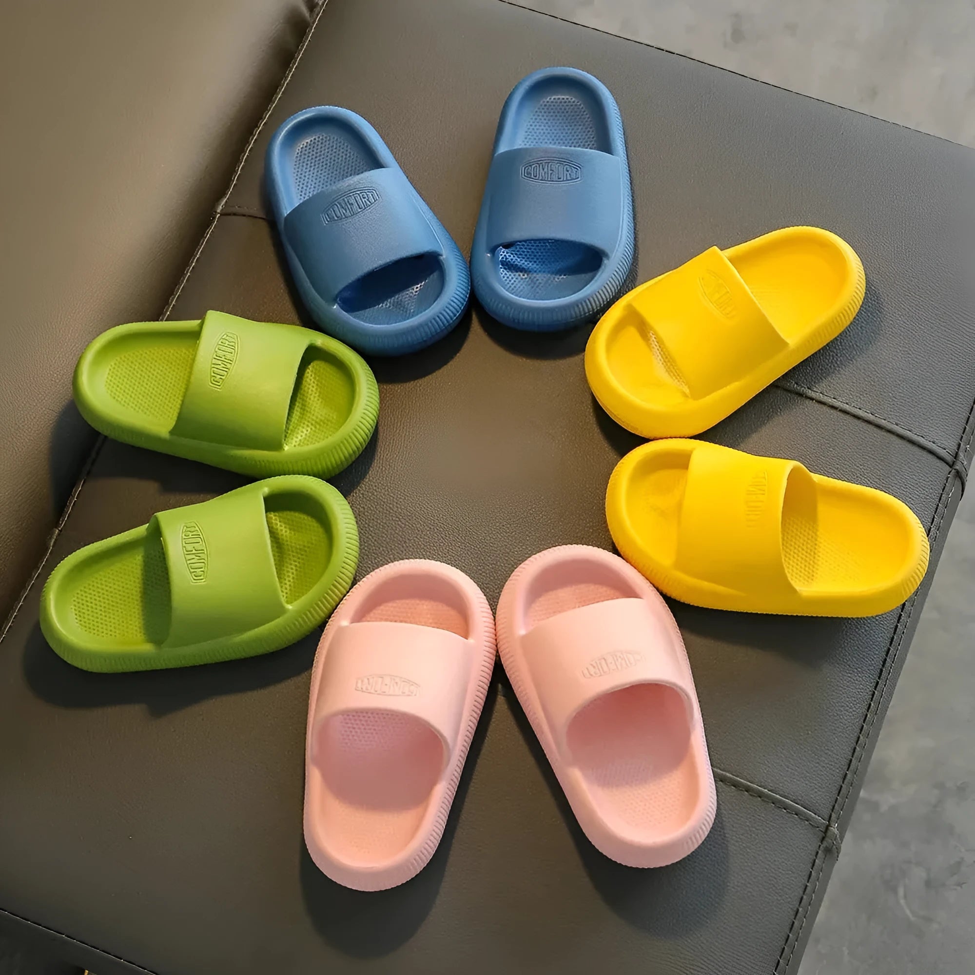 Children's mixed colour EVA slippers with non-slip soles showing size options from 15.5cm to 21.5cm