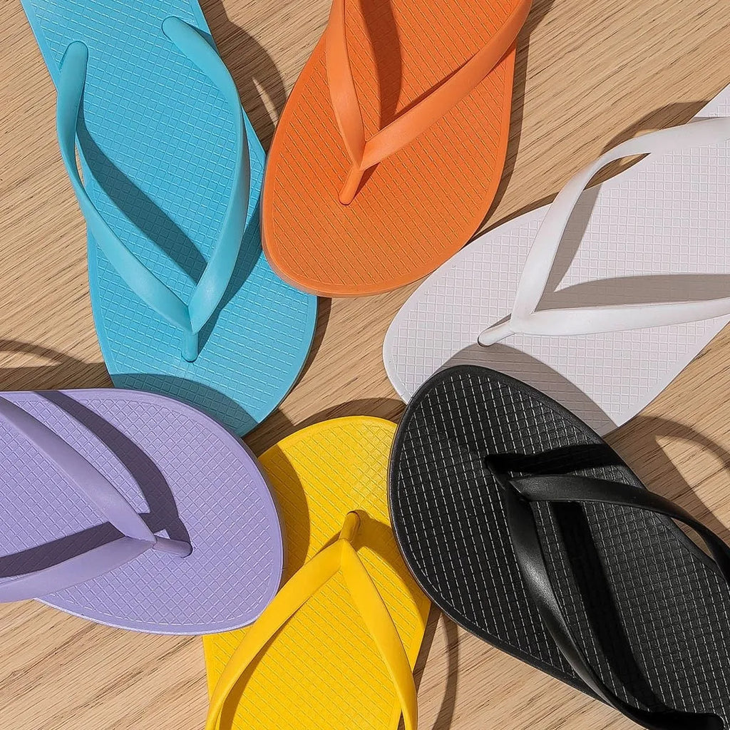 Foldable casual beach slippers in orange colour with hollow out design and non-slip PVC soles.