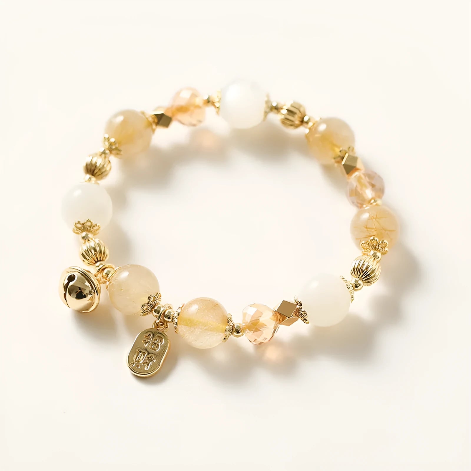 Gold electroplated rutilated quartz bracelet showing Korean style design and lucky fortune gold colour