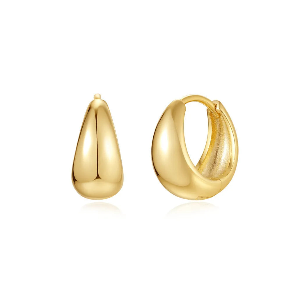 Golden brass earclip earrings with geometric round drop design on white background