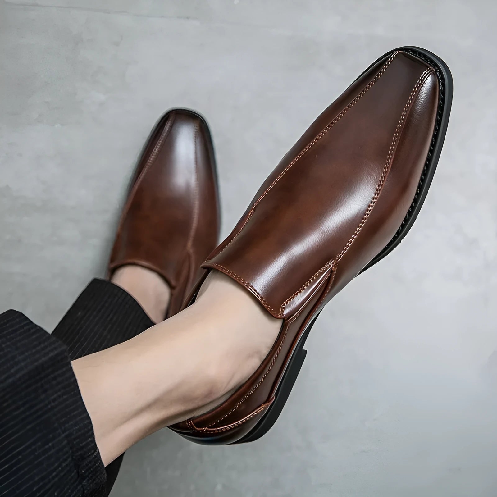 Men's black pointed leather casual shoes with flat rubber sole, shown from side