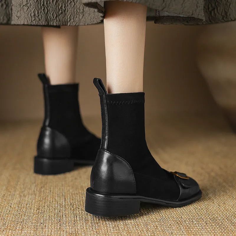 Women's black low-heel Martin boots with belt buckle detail and front lace-up fastening.
