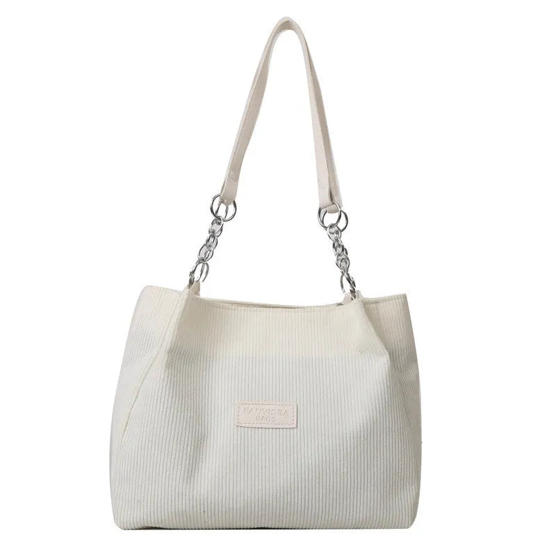 Corduroy one-shoulder tote handbag in street style with three-dimensional pocket
