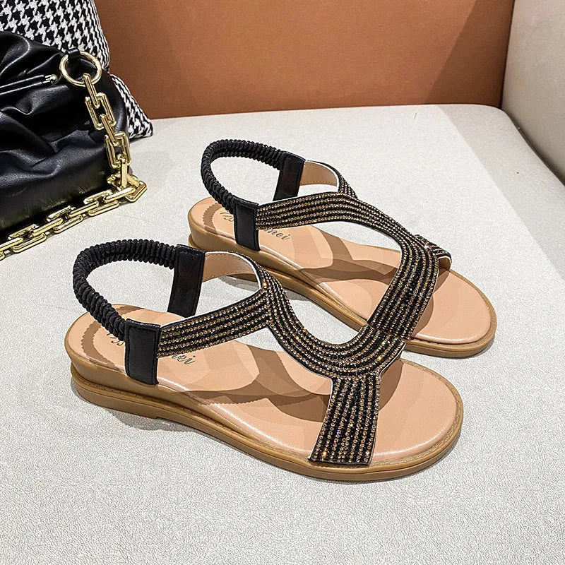 Women's patent leather summer sandals with rhinestone detail on round toe, shown in gold colour