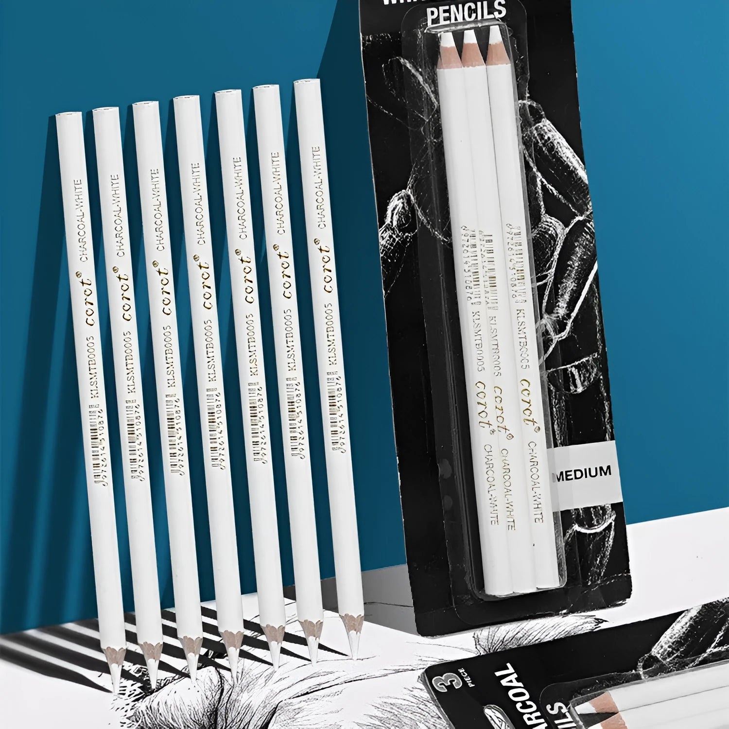 Three white charcoal pencils with wooden casings for drawing on dark paper